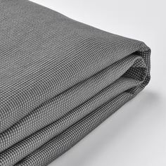 three pieces of grey fabric folded together on top of each other, with one piece missing