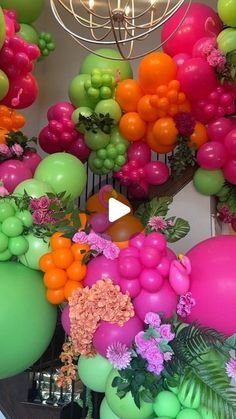 balloons and flowers are hanging from the ceiling