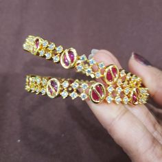 "* Handcrafted Gold Plated Bangle Set * High Quality 22 K Gold Plated 2 pc bangle set; * Sold as a set of 2 bangles Bangles Sizes : 2.4 ( 2.31\" inner circle diameter) ; 2.6 ( 2.43\" diameter of inner circle); 2.8 (2.54\" diameter of inner circle) The gorgeous gold-plated bangle/ bracelet best exemplifies the careful craftsmanship done on it -- a specialty at Nemali Jewelry. It has a special tone of elegance attached to it. The intricate handmade design of the bangle/bracelet set gives it a fres Bangle Set Pink, Traditional Adjustable Pink Bangle, Celebration Gold-plated Hand-set Bangle, Ornate Gold Hand-set Bangle, Festive 22k Gold Hand-set Bangle, Cz Bangles, Wedding Bangles, Bollywood Bridal, Bangles Set