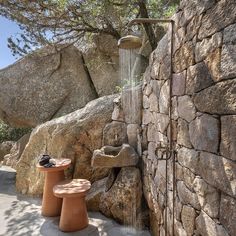 an outdoor shower in the middle of some rocks