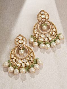 This designer chand baali earring is a handcrafted marvel, adorned with multi-shaped polkis, baroque pearls, and green agates. Perfect for festive occasions, weddings, and parties, it effortlessly enhances both Indian and fusion attire. Every piece is meticulously crafted with real semi-precious stones, imparting a regal look and feel to each artistic creation. Finish: 22KT Gold Plating Material: Brass, Polkis, Beads, Baroque Pearls Color: Gold, Green, White Size: One Size Closure Type: Push Loc Girly Jewellery, Polki Chandbali, Kundan Chandbali, Bridal Jewellery Online, Hand Jewelry Rings, Polki Earrings, Chandbali Earrings, Bangles Indian, Bangles Jewelry Designs