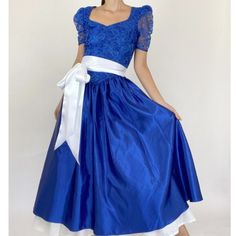 Gorgeous Vintage Deadstock Dress. Still New! A Vibrant Royal Blue In Color, Features A Lace Bodice And Satin Skirt. Back Has Keyhole Cutout With Beaded Pearl Detailing. Shown On Its Own And Stayed Over A Petticoat With A Sash. The Perfect Formal Gown. Size 9/10. Polyester Fabric. Approx: Bust: 34-36" Waist: 28-30" Hip: Free Shoulder-Hem: 52" Retro Blue Puff Sleeve Dress, Royal Blue Lace, Formal Gown, Satin Skirt, Lace Bodice, Formal Gowns, Petticoat, Blue Lace, Puff Sleeve