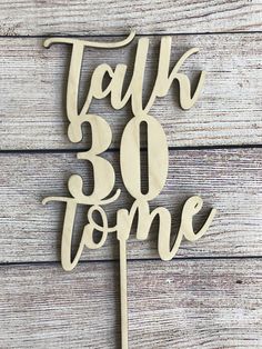 a wooden cake topper that says talk 30 to me