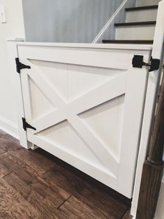 a white barn door with black hardware on the bottom and side panels that are open