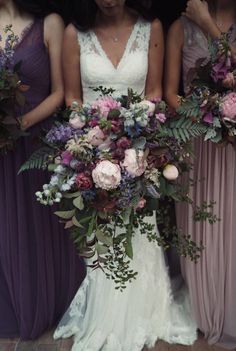 the bridesmaids are holding their bouquets with purple and pink flowers on them