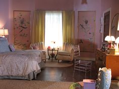 a bedroom with pink walls and furniture in it