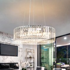 a chandelier hanging from the ceiling in a living room