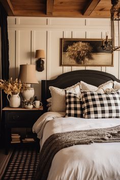 a black and white checkered bed with two lamps on either side of the headboard