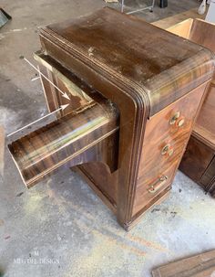 an old wooden desk with two drawers on it's sides and one drawer open