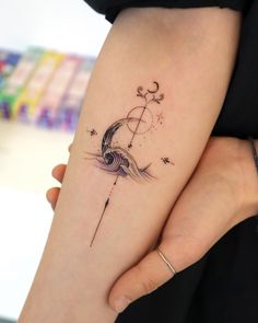 a woman's arm with a tattoo on it and an arrow in the middle