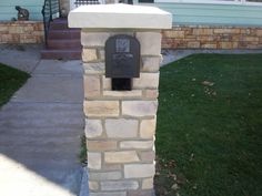 a mailbox on the sidewalk in front of a house