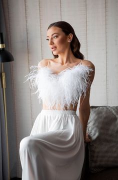 Make your wedding day even more memorable with this exquisite silk bridal pajama set. Feel glamorous and relaxed from morning preparations to your wedding night. This wedding pajama set includes long silk culottes that flow gracefully with every movement and a feather top that adds a touch of glamour. It's perfect for the bride who wants to feel as beautiful while getting ready as she does walking down the aisle. * Handmade * High-quality soft Armani silk * Made to measure * Feathers on buttons White Satin Sets For Wedding Night, White Satin Sleepwear For Evening, White Satin Wedding Sleepwear, Bridal Pajama Set, Silk Culottes, Bride Pajamas, Bride Pajama, Feather Top, Bridal Pajamas