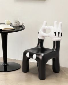 two black and white chairs sitting next to each other on top of a wooden floor