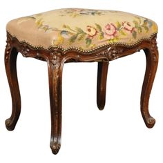 a small wooden stool with flowers on it