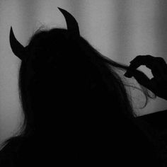 the silhouette of a woman with horns on her head