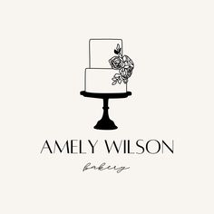 a logo for a bakery with a cake and flowers on the top, in black and white