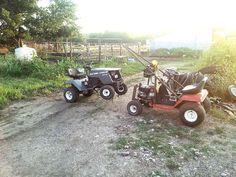 two atvs parked next to each other on a dirt road