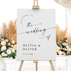 an easel with a sign that says welcome to the wedding