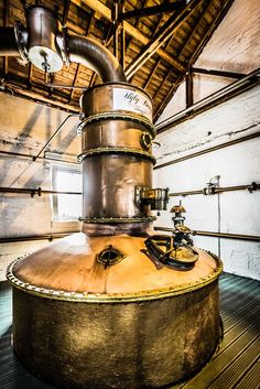 a large metal tank sitting on top of a wooden floor