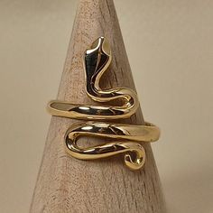 Simple, elegant handmade ring in shape of snake The ring is made of 18 carat solid yellow gold It's an adjustable ring from size U.S 6.1/2 to 9.00 Snake was the symbol of health in ancient Greece The ring is made in Greece in our workshop in Athens An elegant classic piece of jewelry SHIPPINGINFORMATION FREE SHIPPING VIA DHL EXPRESS Please fill an active phone number It is required by the courier company DELIVERY INFORMATION 1-3 Working days To EUROPE 3-5 Working days To U.S.A, and CANADA 5-8 Wo Yellow Gold Snake-shaped 14k Gold Rings, Elegant 14k Gold Snake-shaped Ring, Snake-shaped Yellow Gold Wedding Ring, Elegant Gold Snake Ring, Elegant 14k Gold Snake Shaped Rings, Gold Snake Ring As Gift, Unique Gold Snake Ring For Formal Events, Unique Gold Snake Ring For Formal Occasions, Adjustable Gold Snake Ring