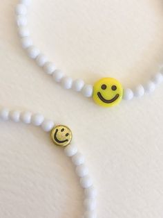 "customize your very own happy smiley face stretchy bracelet, made to order in your size! you will receive one white beaded bracelet with your choice of center smiley bead (gold or yellow). PLEASE NOTE: you will receive ONE bracelet with this order. these super trendy and versatile stretch bracelets are the perfect little accessory for your wrist. they are dainty and beautiful by themselves, but also look great when combined and stacked. you can add to your stack right here: http://www.etsy.com/ White Stretch Bracelet With Smiley Face For Gift, White Bracelets With Smiley Face For Gift, Everyday White Bracelets With Smiley Face, White Smiley Face Bracelet As Gift, Cheerful Adjustable White Beaded Bracelets, Adjustable Cheerful White Beaded Bracelets, Playful White Friendship Bracelets With Smiley Face, Cheerful White Adjustable Beaded Bracelets, Cheerful White Beaded Bracelets With Round Beads