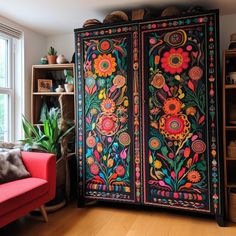 an ornately decorated armoire in a living room