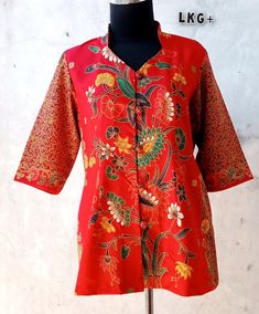 "I will make a batik shirt based on the sample model in the picture, but with a choice of different batik colors and patterns as shown in the picture.  This batik blouse will be made using premium cotton batik cloth, so it is comfortable to wear.  There are 5 choices of batik cloth colors 🌸The basic size of the clothes is based on the clothes size table listed. - The length of the blouse from shoulder is about 70 cm (27.5\") - 3/4 sleeve - Two pockets - Closure: button ** Care Instruction: - Gently Handwash - Do not use detergent ( Use Shampoo or liquid soap ) 🌸 Thank You 🌸" Cotton Batik Print Short Sleeve Tops, Short Sleeve Cotton Tops With Batik Print, Traditional Cotton Patterned Tops, Traditional Short Sleeve Printed Blouse, Red Printed Cotton Blouse, Traditional Patterned Tops With Motif, Cotton Shirt With Batik Print, Patterned Cotton Shirt With Batik Print, Bohemian Cotton Shirt With Batik Print