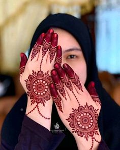 a woman with her hands covered in henna