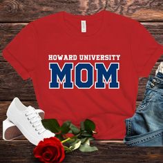 Howard University Bella Canvas Unisex T-Shirt (Sizes Small to 4X) Show your Bison pride with this stylish and comfortable Bella Canvas unisex t-shirt! Perfect for students, alumni, and fans of Howard University, this tee is a must-have addition to your wardrobe. Whether you're a proud mom, sister, auntie, or grandma, this shirt is designed to celebrate your connection to Howard University. Product Details: Brand: Bella Canvas Material: 100% Airlume combed and ring-spun cotton (heather colors contain polyester) Sizes Available: Small to 4X Fit: Unisex sizing for a relaxed and comfortable fit Features: Soft and lightweight fabric Durable and long-lasting print Available in red or Navy Perfect for everyday wear or special occasions Care Instructions: Machine wash cold, inside-out, with like c Short Sleeve Fan Apparel Tops For School, Casual T-shirt With Name Print For School, Casual School T-shirt With Name Print, Casual Red Tops For Mother's Day, Red Casual Tops For Mother's Day, School Spirit T-shirt With Name Print In Relaxed Fit, Cotton School Fan Apparel Tops, Cotton Fan Apparel Tops For School, Casual College Shirt With Name Print