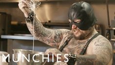 a tattooed man wearing a mask and holding a ladle in his hand with the words munchies on it