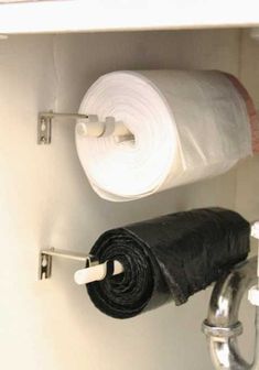 there is a roll of toilet paper on the wall next to two rolls of black towels