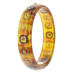 This bangle, crafted of stunning marbled tortoiseshell bakelite, from the Mark Davis Collector Line, is radiant. Inlaid pieces of navy blue or pale green bakelite form a pattern that encircles the vintage bangle. Citrine, peridot, and smoky quartz are bezel-set in 18k yellow gold and placed at the center of each inlaid square. Metal 18-Karat Yellow Gold (750) Gemstones Citrine 0.35 ctwPeridot 0.42 ctwSmoky Quartz 0.35 ctw Dimensions Inner Diameter 63.00 mm (2.48 in)Inner Circumference 197.92 mm Elegant Tortoiseshell Bangle Jewelry, Elegant Bakelite Bangle As Gift, Elegant Bakelite Bangle As A Gift, Bakelite Bangles, Vintage Bangles, Cartier Love Bracelet, Pale Green, Smoky Quartz, Tortoise Shell