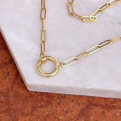 14KT yellow gold paper clip link chain with center, round clasp that opens on a hinge. Center clasp is PERFECT for adding on pendants and charms! Length: 18" Chain width: 3.20mm Weight: 4.20 grams Front facing, circle clasp that pushes open on a hinge Stamped 14k Hollow paper clip links Charms shown are sold separately Paper Clip Chain Necklace, Pearl Accessories, Charm Holder, White Gold Bracelet, Rose Gold Pendant, Back Jewelry, White Gold Necklaces, Gold Paper, White Gold Earrings