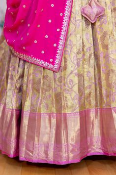 This elegant Gold and Light Pink Border Kanjivaram tissue silk Lehenga features an embroidered dupatta for a touch of sophistication. Perfect for any special occasion, this garment is sure to make an impression. Festive Anarkali Sets In Brocade, Anarkali Tussar Silk Wedding Sets, Festive Anarkali Brocade Sets, Designer Semi-stitched Brocade Embroidered Fabric, Bollywood Style Brocade Sets With Zari Work, Semi-stitched Brocade Sets With Zari Work, Brocade Saree Sets For Festivals, Festival Brocade Saree Sets, Transitional Tissue Silk Anarkali Set With Zari Work