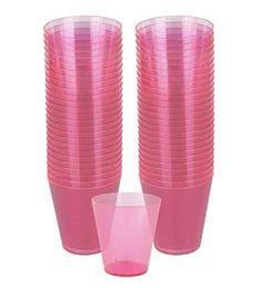 pink plastic cups are stacked on top of each other