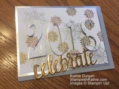 a close up of a greeting card on a wooden table with the words celebrate written in gold