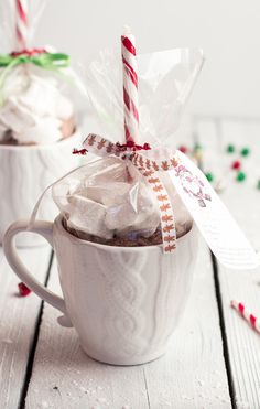 two cups filled with hot chocolate and candy canes