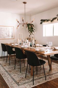 a dining room table is set with black chairs and place settings for six people to eat