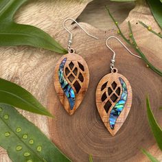 **ALL ITEMS ARE MADE TO ORDER, AND REQUIRE 5-7 BUSINESS DAYS TO COMPLETE BEFORE SHIPPING** Our earrings are made with the highest quality hand milled, laser cut Hawaiian Koa, from the Big Island's Kona side. These earrings include an abalone veneer inlay. This design is .9 inches wide by 1.7 inches high by .1 inches thick. We manufacture our own Koa sheets in very small batches, using reclaimed wood from the offcuts from local wood mills, and as such, each batch of Koa has wide variations of character. The pair of earrings you receive may differ slightly in look from the pictures in the listing, but we use only the finest Koa for our earrings and pendants. All of our earring hooks are high quality silver plated stainless steel, and are nickel-free and hypoallergenic. Our earrings are finis Laser Necklace Design, Wood Earrings Diy, Laser Engraved Earrings, Wood Jewelry Diy, Laser Cut Wood Earrings, Laser Cut Wood Crafts, Wooden Jewellery, Filigree Pattern, Kailua Kona