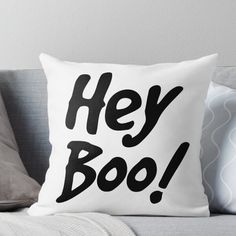 a black and white pillow with the words hey boo written in cursive font