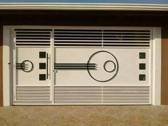 a white garage door with an abstract design on the side and shutters in front