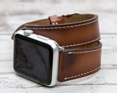 "Genuine leather brown Apple Watch wrap, 42mm, 38mm, 40mm, 44mm for series 1-6 & SE. Size: This strap is medium size and fits 150-190 mm (5.9\"-7.4\") wrists. Seven different color options for adapters (Silver, Black, Space Gray, Rose Gold, Yellow Gold, Red and Blue). Adapter color and buckle color will be same. Shipping: Shipping within US takes usually 3 business days via USPS/FedEx, to Europe 1 business day via TNT Express. We normally send orders in 1 or 2 business days. Customization: W Apple Watch Space Grey, Apple Watch Silver, Brown Apple, Apple Watch Bands Women, Rose Gold Apple Watch, Band Fits, Apple Watch Bands Leather, Apple Watch Series 1, Apple Watch Band