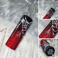 the red and black spider web canister is sitting on top of a fur rug