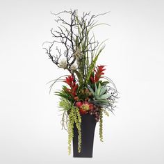 a tall black vase filled with lots of different types of flowers and plants in it