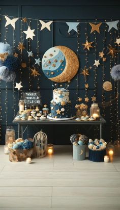 a table topped with cakes and cupcakes covered in blue frosting