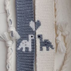 two crocheted bookmarks with white and blue designs on them, one has an elephant and the other is a giraffe