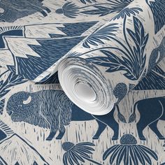 a blue and white wallpaper with an animal design on the bottom half of it