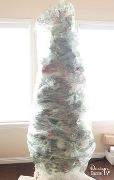 there is a very large christmas tree made out of plastic wrap and wrapped around the base