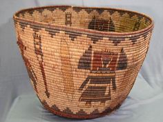 an old woven basket with designs on it