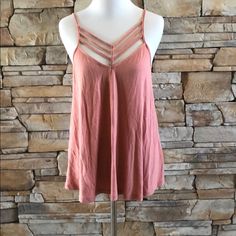 Express Strappy Top. Brand New With Tag. Split Hem, Slightly Longer In Back. Modal Cotton/Polyester/Spandex. Light Salmon Color. Would Also Fit A Medium. Runs Big. Strappy Summer Tank Top For Beach, Summer Strappy Camisole With Crisscross Straps, Summer Camisole With Crisscross Straps, Strappy Tank Top For Summer Day Out, Strappy Camisole For Spring Day Out, Trendy V-neck Top With Crisscross Straps, Trendy Spring Tank Top With Crisscross Straps, Pink Beach Top With Straps, Pink Beach Tops With Straps